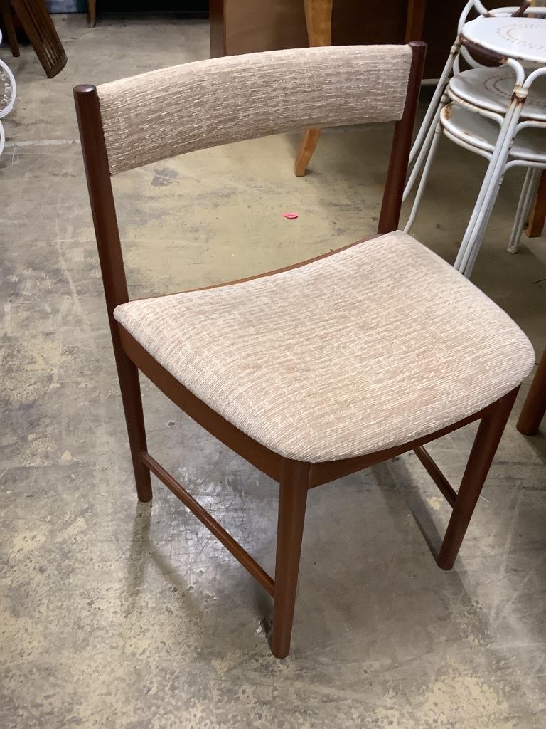 A mid century design Macintosh circular teak extending dining table and four chairs, model 9533, table width 170cm extended depth 122cm height 74cm